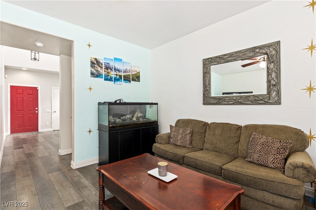 2664 Strichen Avenue Henderson, NV 89044 - Photo 5 of 25 Living area featuring dark wood-style floors, base