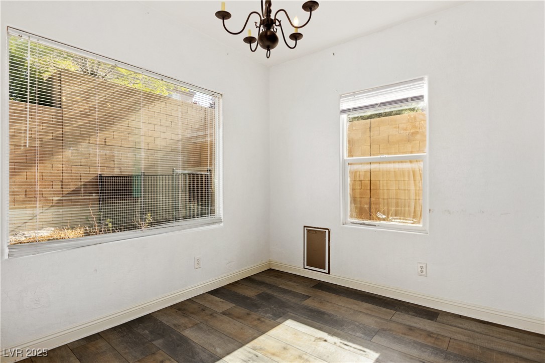 2664 Strichen Avenue Henderson, NV 89044 - Photo 8 of 25 Empty room with baseboards, a notable chandelier,