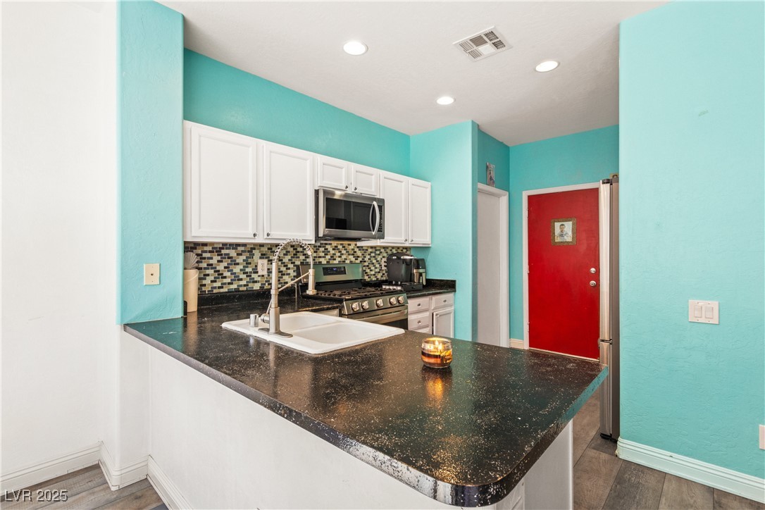 2664 Strichen Avenue Henderson, NV 89044 - Photo 10 of 25 Kitchen featuring a sink, tasteful backsplash, woo