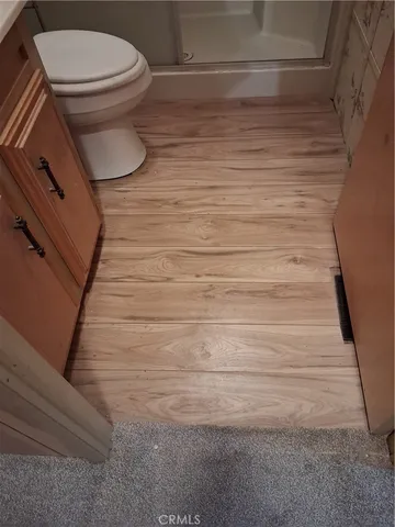 a bathroom with a toilet and a shower