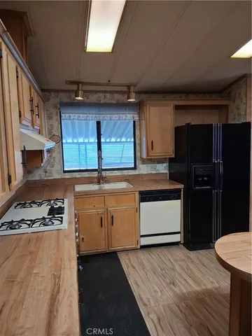 a kitchen with a stove a refrigerator and a sink