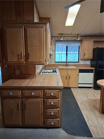 a kitchen with stainless steel appliances granite countertop a sink and a stove