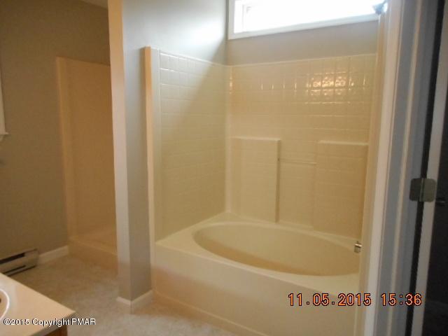 151 Ryan Road Blakeslee, PA 18610 - Photo 12 of 13 a white bath tub sitting next to a shower