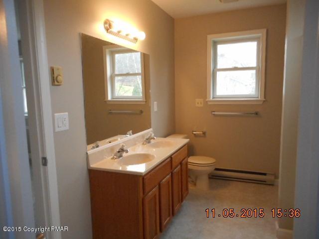 151 Ryan Road Blakeslee, PA 18610 - Photo 13 of 13 a bathroom with a toilet sink and mirror