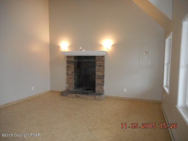 151 Ryan Road Blakeslee, PA 18610 - Photo 3 of 13 an empty room with a fireplace