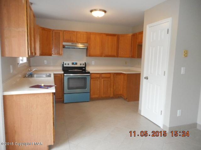 151 Ryan Road Blakeslee, PA 18610 - Photo 6 of 13 a kitchen with stainless steel appliances granite countertop a stove a sink and a refrigerator