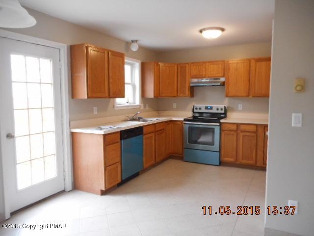 151 Ryan Road Blakeslee, PA 18610 - Photo 7 of 13 a kitchen with stainless steel appliances granite countertop a stove a sink a refrigerator a window and cabinets