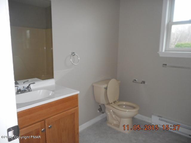 151 Ryan Road Blakeslee, PA 18610 - Photo 8 of 13 a white toilet sitting next to a bathroom sink