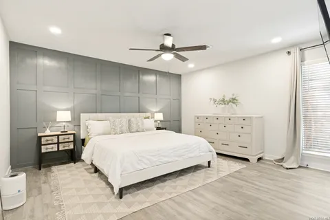a bedroom with a bed and wooden floor