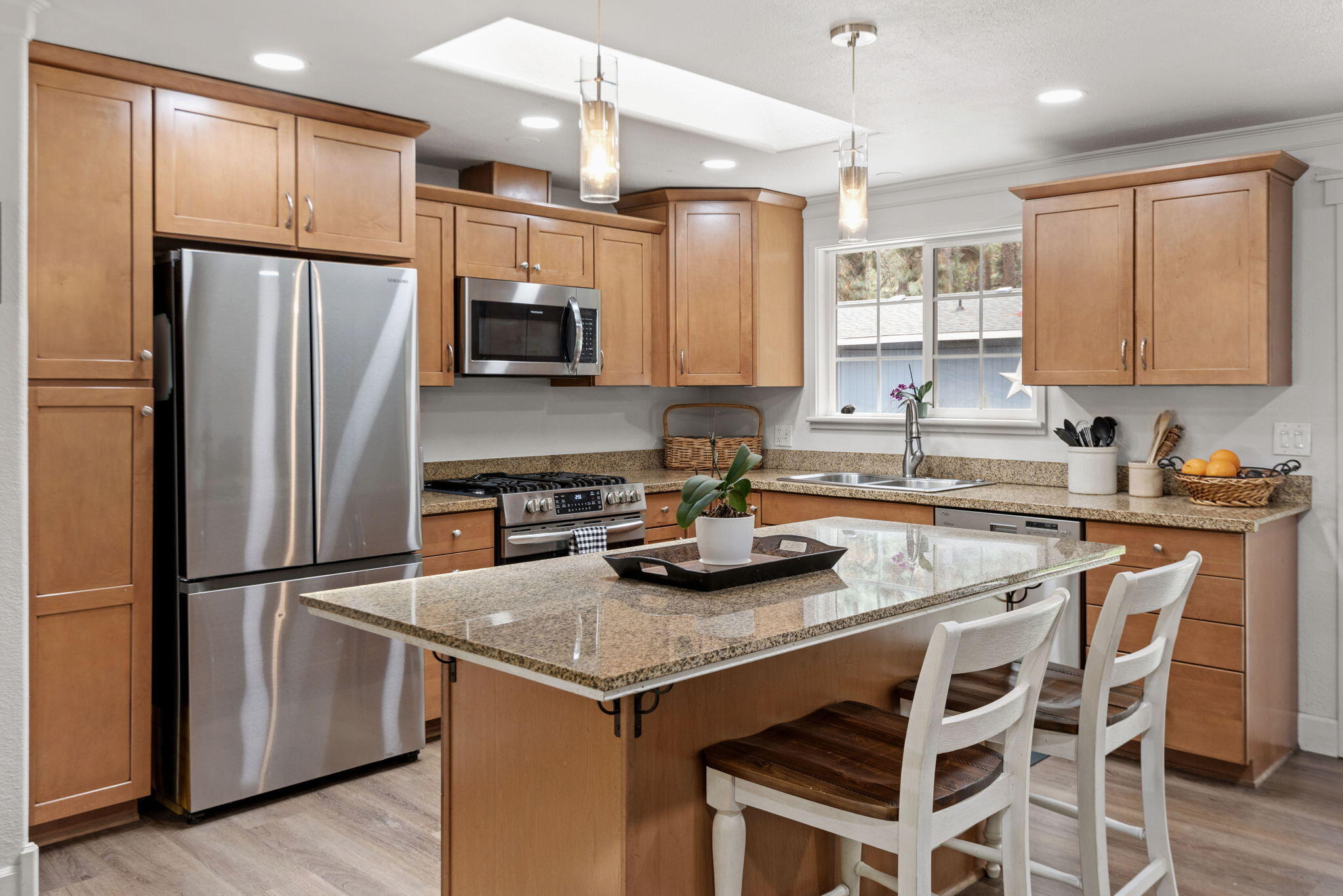 19115 Kiowa Road Bend, OR 97702 - Photo 7 of 35 a kitchen with granite countertop stainless steel appliances a refrigerator a sink and a stove