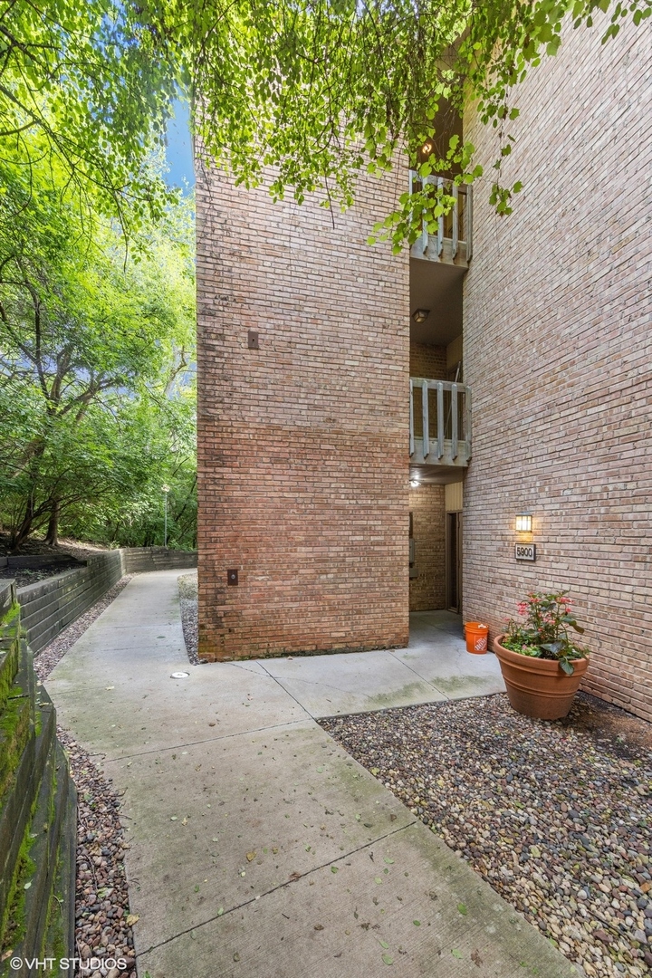 5900 Forest View Road, Unit 2A Lisle, IL 60532 - Photo 1 of 24 a view of a pathway with plants and trees