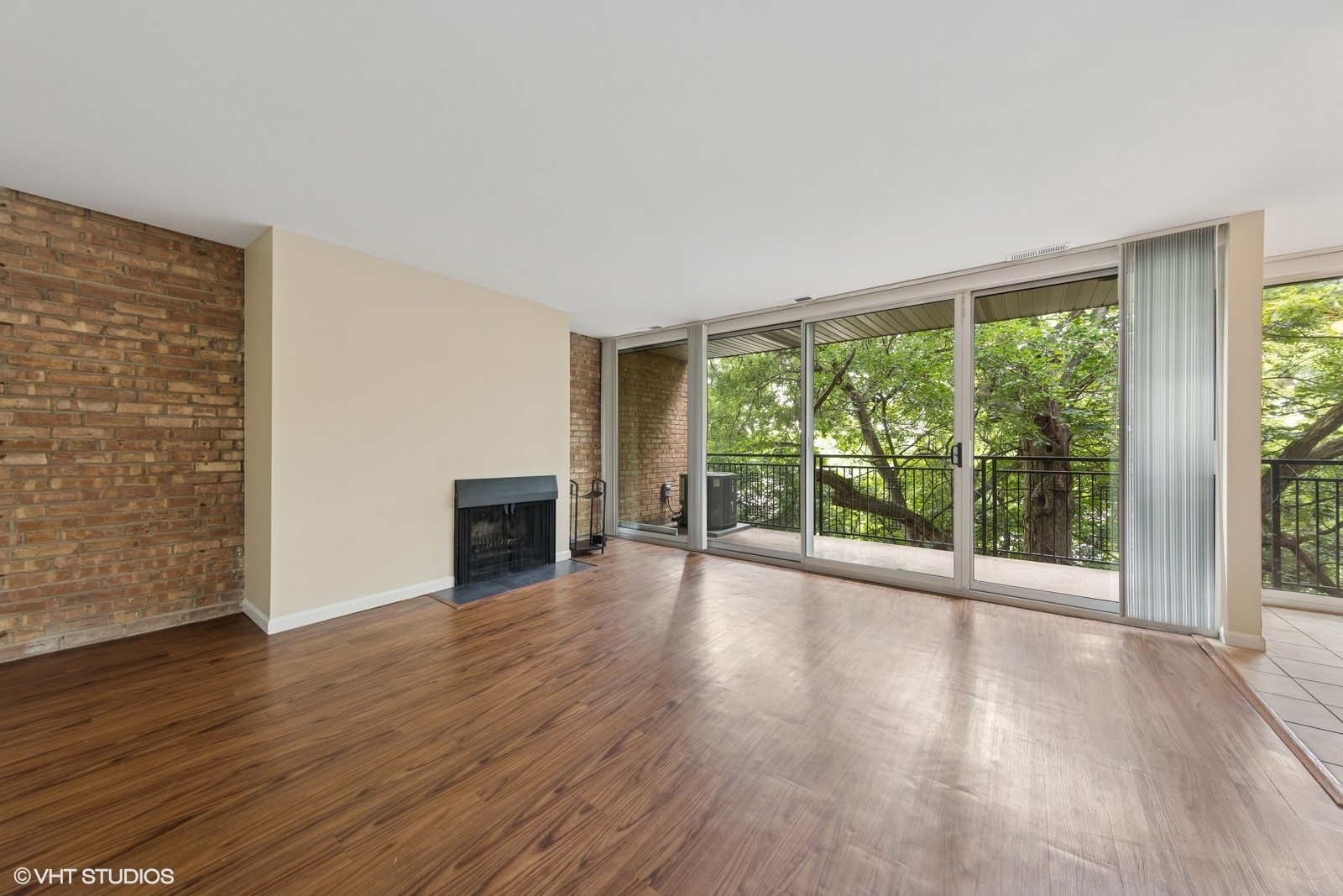 5900 Forest View Road, Unit 2A Lisle, IL 60532 - Photo 4 of 24 a view of empty room with wooden floor and fireplace
