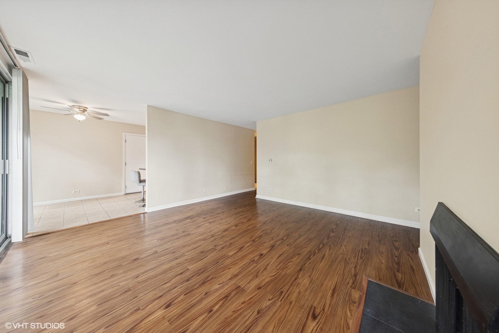 5900 Forest View Road, Unit 2A Lisle, IL 60532 - Photo 5 of 24 a view of an empty room with wooden floor and a window