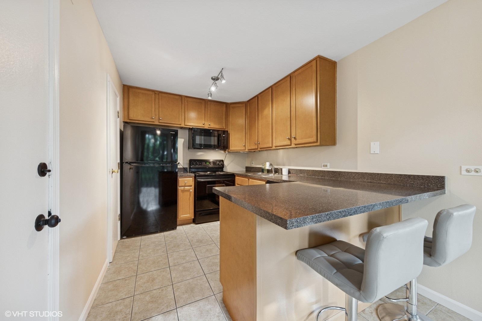 5900 Forest View Road, Unit 2A Lisle, IL 60532 - Photo 7 of 24 a kitchen with kitchen island a counter top space a sink appliances and cabinets