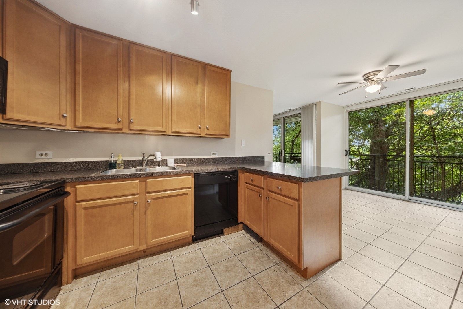 5900 Forest View Road, Unit 2A Lisle, IL 60532 - Photo 8 of 24 a kitchen with stainless steel appliances granite countertop a stove a sink and a microwave