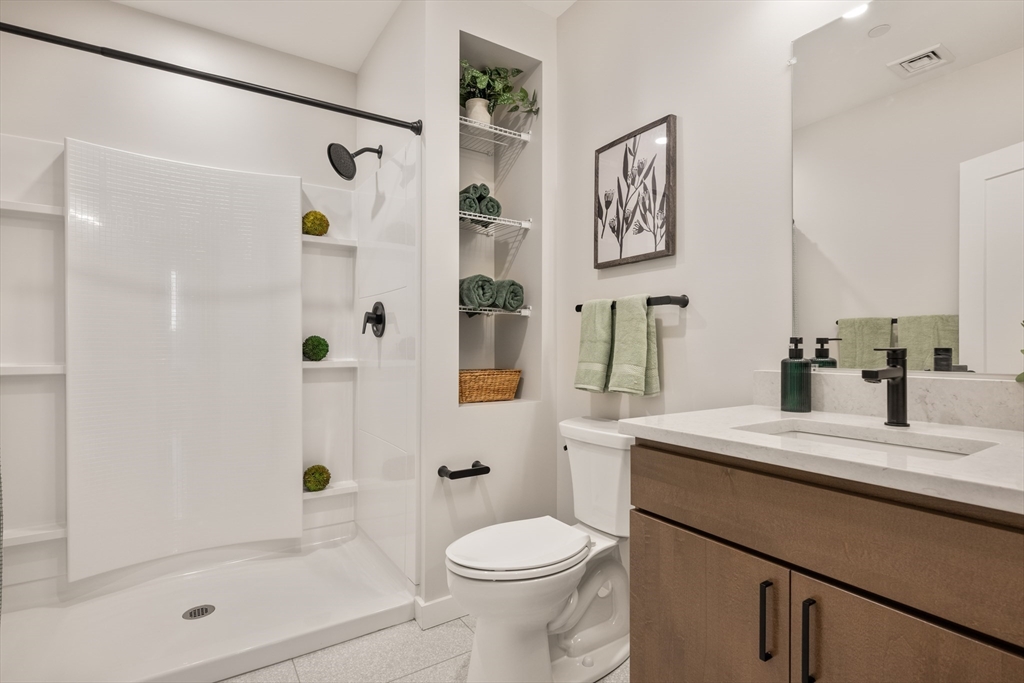 22 Elm Street, Unit 401 Worcester, MA 01608 - Photo 15 of 18 a bathroom with a sink toilet and shower