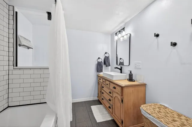 a bathroom with a sink a toilet and mirror
