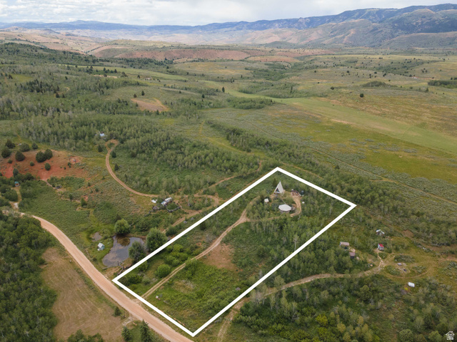 23 Scare Canyon, Unit 23 Logan, UT 84321 - Photo 31 of 33 Expansive land parcel featuring a main structure, circular clearing, mature trees, and a dirt road entrance