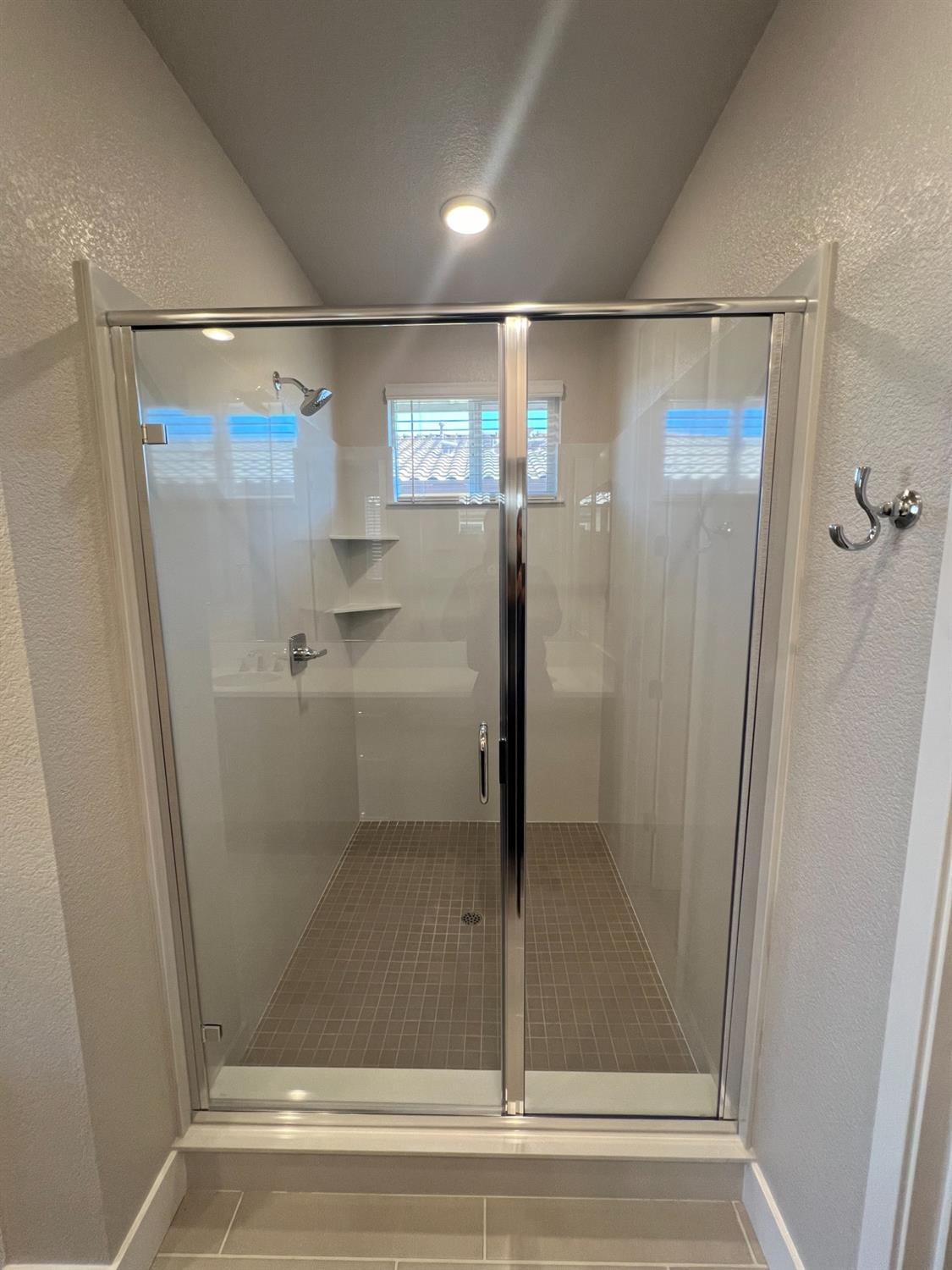 3063 Banano Way Rancho Cordova, CA 95742 - Photo 12 of 20 a bathroom with a glass shower door