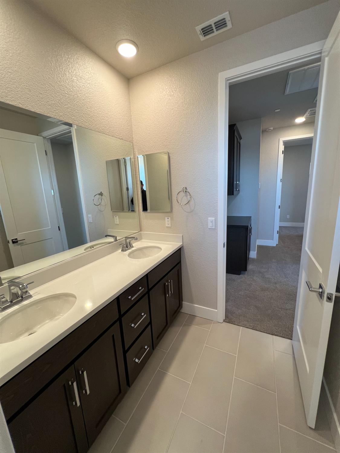 3063 Banano Way Rancho Cordova, CA 95742 - Photo 17 of 20 a spacious bathroom with a double vanity sink a mirror and a shower