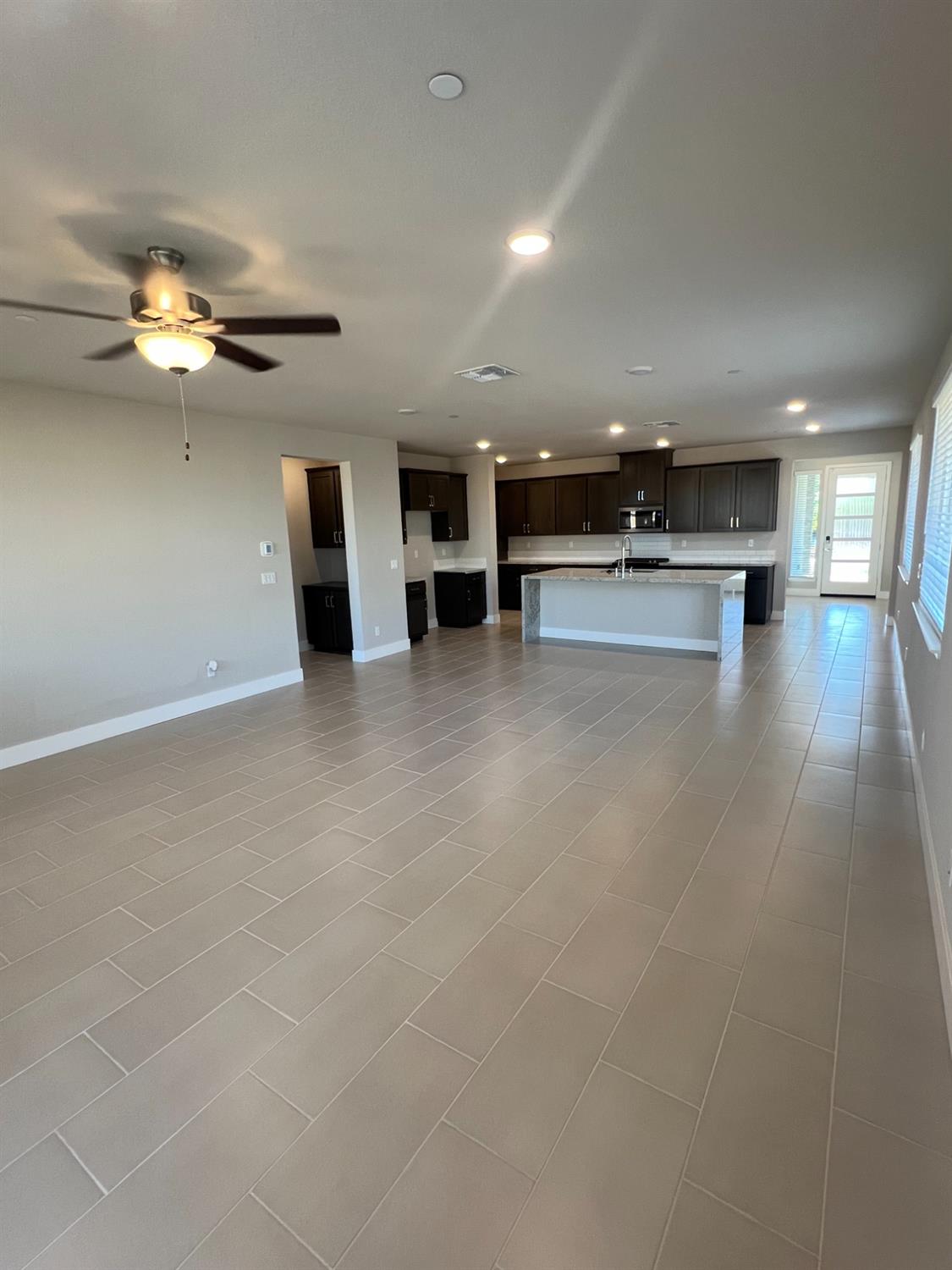 3063 Banano Way Rancho Cordova, CA 95742 - Photo 8 of 20 an empty room with kitchen view and a stove