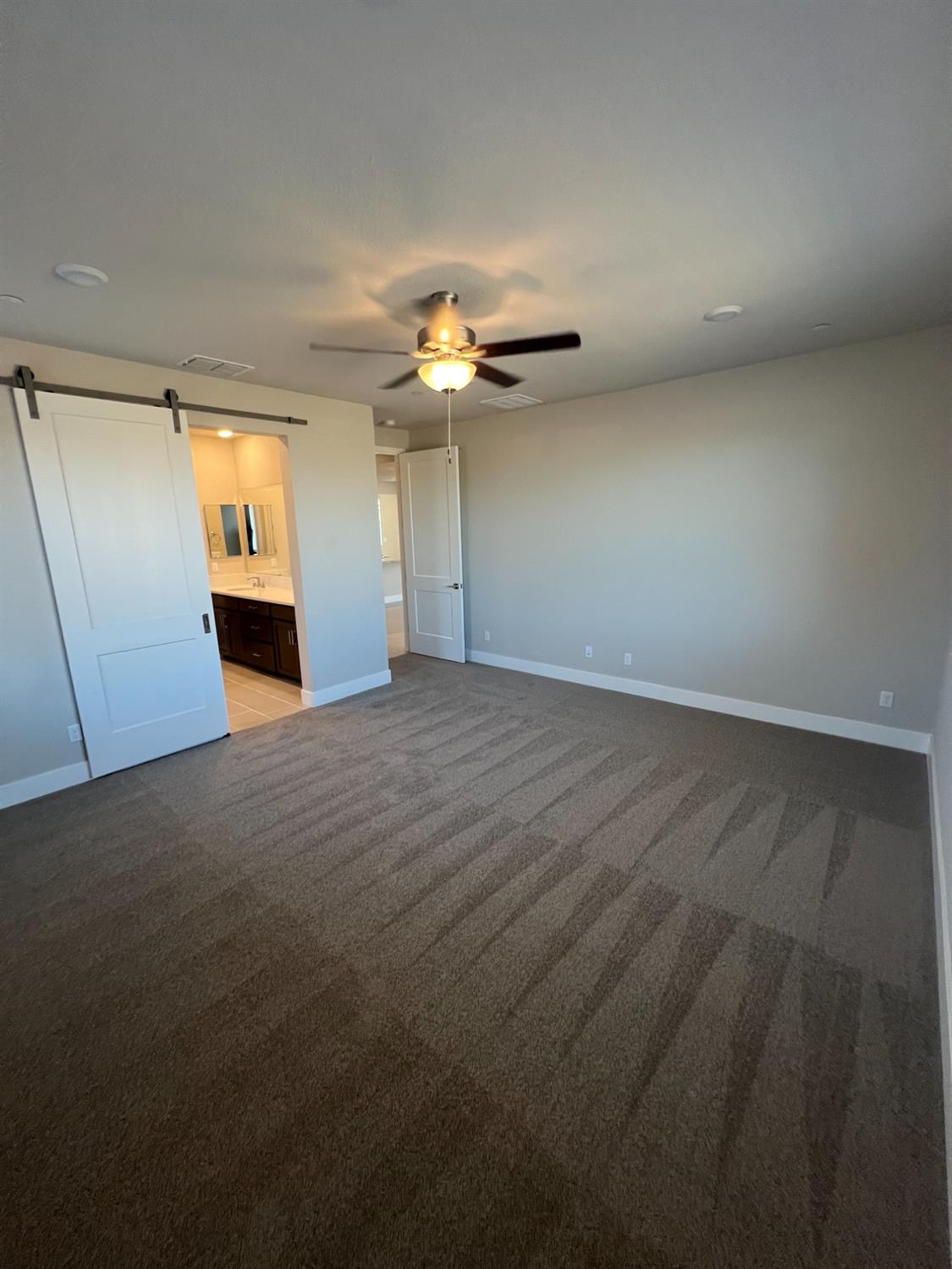 3063 Banano Way Rancho Cordova, CA 95742 - Photo 10 of 20 an empty room with a ceiling fan and a window