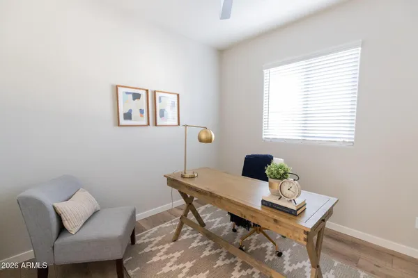 a view of a workspace with furniture and a window