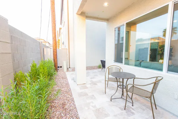 a patio with yard and outdoor seating