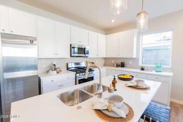 a kitchen with a stove a sink and a refrigerator
