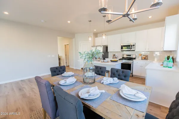 a open dining room with stainless steel appliances kitchen island granite countertop furniture and a kitchen view