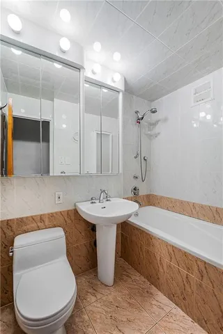 a bathroom with a toilet a sink and bathtub