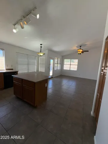 a kitchen with stainless steel appliances granite countertop a sink a stove top oven a counter space and cabinets