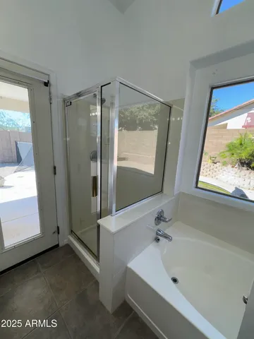 a bathroom with a tub and a shower
