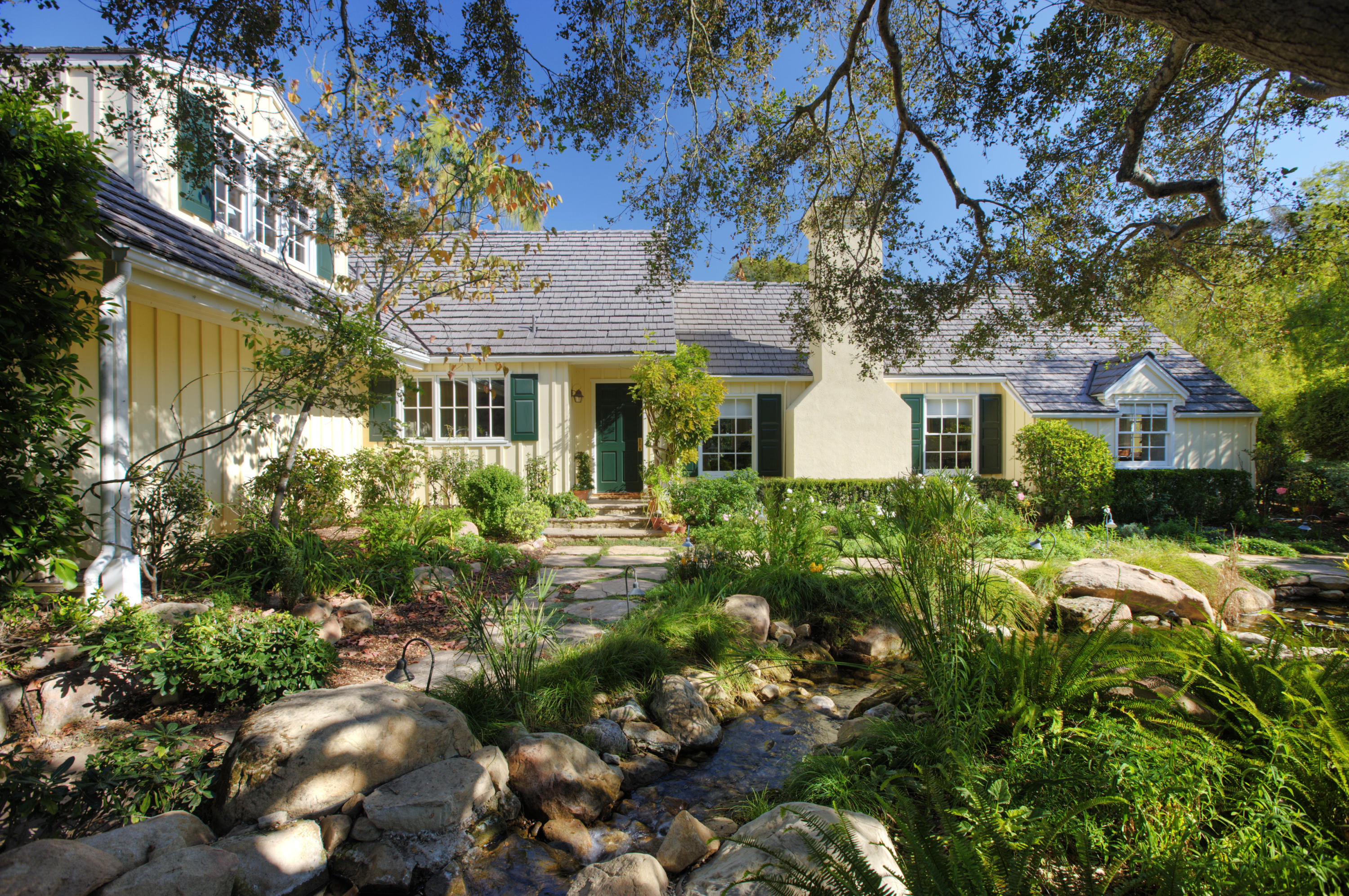 1966 East Valley Road Santa Barbara, CA 93108 - Photo 3 of 16 a front view of a house with a yard and shrubs