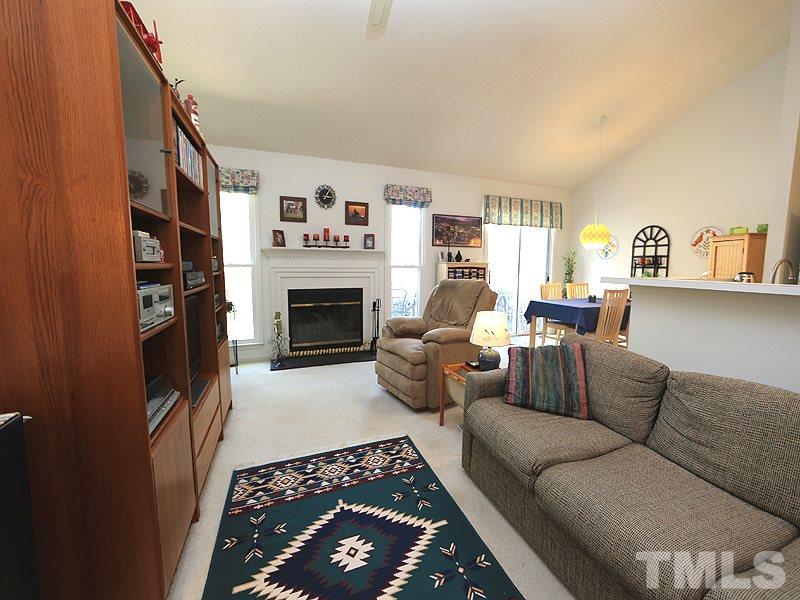 4601 Knightsbridge Way Raleigh, NC 27604 - Photo 3 of 12 a living room with furniture a fireplace and a large window
