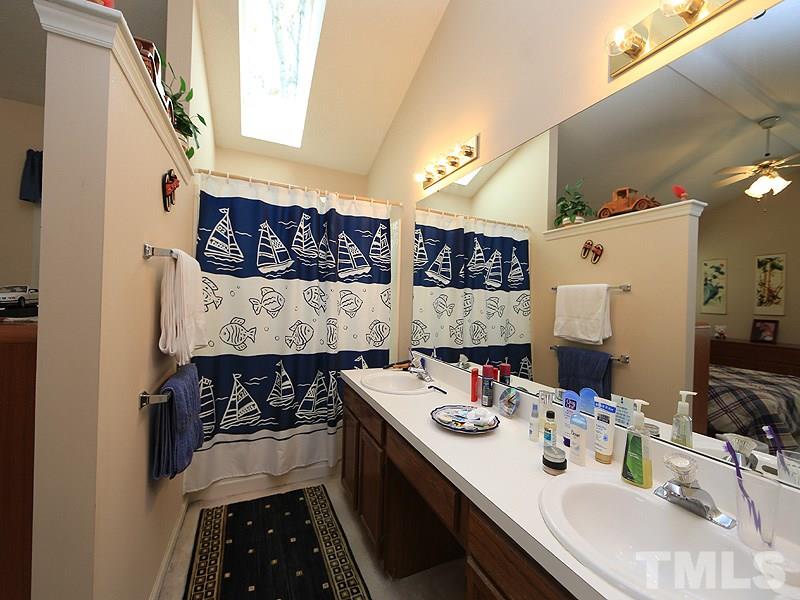 4601 Knightsbridge Way Raleigh, NC 27604 - Photo 8 of 12 a kitchen with a sink stove and cabinets