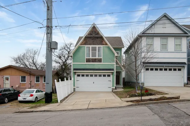 a front view of a house with a parking area
