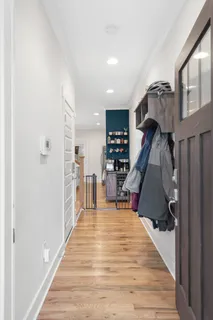 a view of entryway and hall with wooden floor