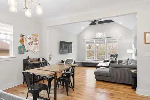 a living room with furniture a table and a large window