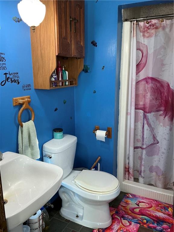 1652 Frew Mill Road New Castle, PA 16101 - Photo 14 of 25 a bathroom with a toilet and a shower curtain