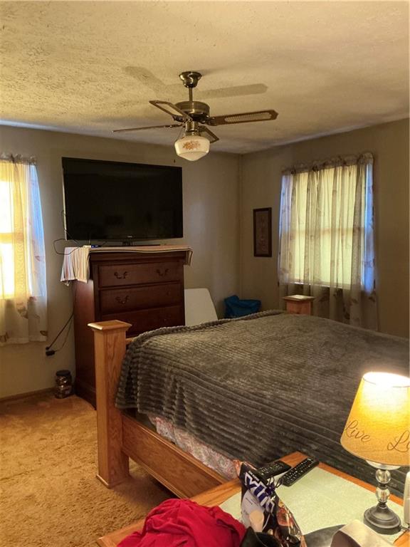 1652 Frew Mill Road New Castle, PA 16101 - Photo 17 of 25 a bedroom with a bed and a chandelier