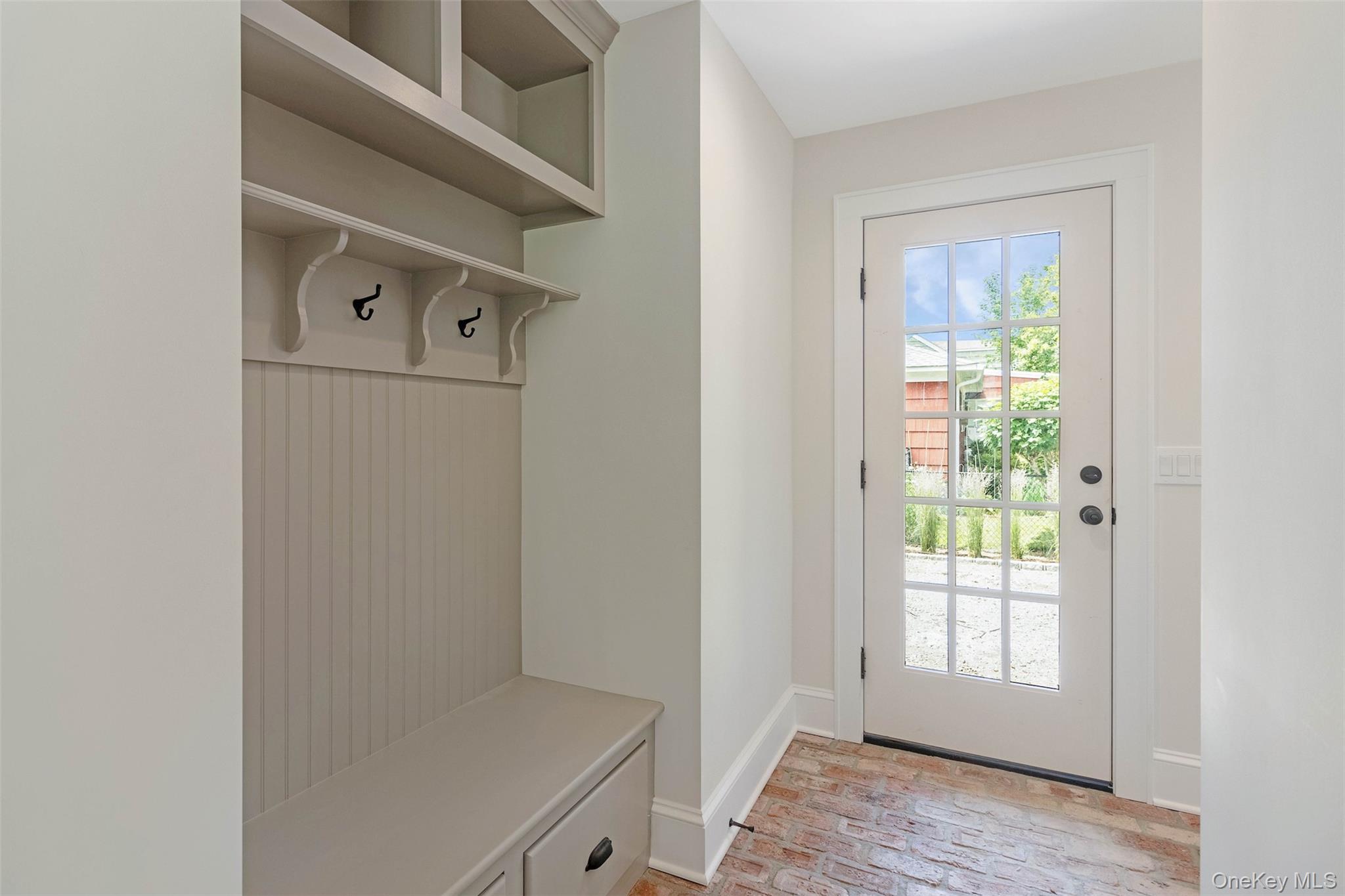 130 Sunset Lane Greenport, NY 11944 - Photo 10 of 34 Mudroom featuring brick floors and baseboards