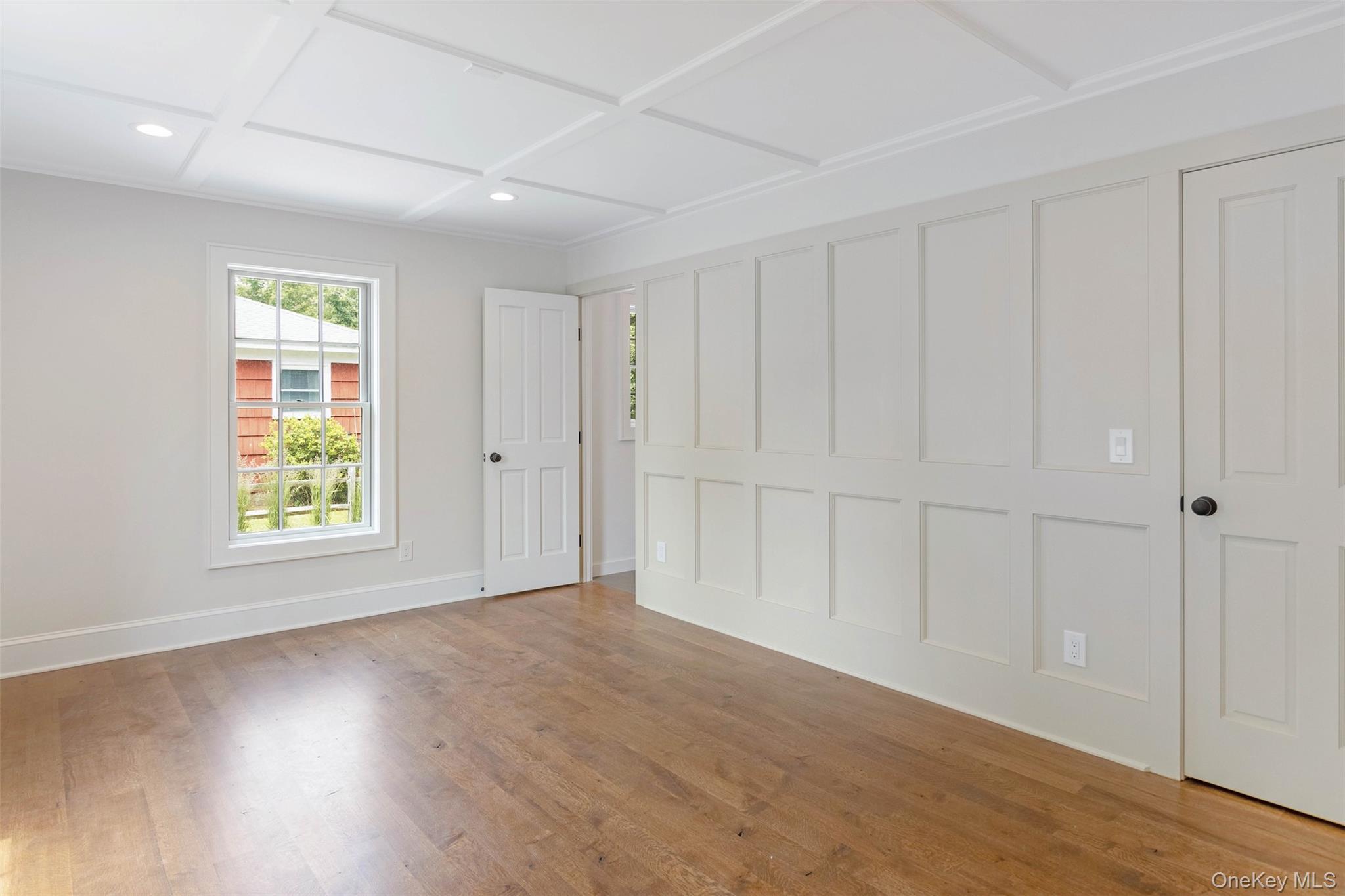130 Sunset Lane Greenport, NY 11944 - Photo 13 of 34 Unfurnished bedroom featuring wood finished floors, coffered ceiling, and recessed lighting