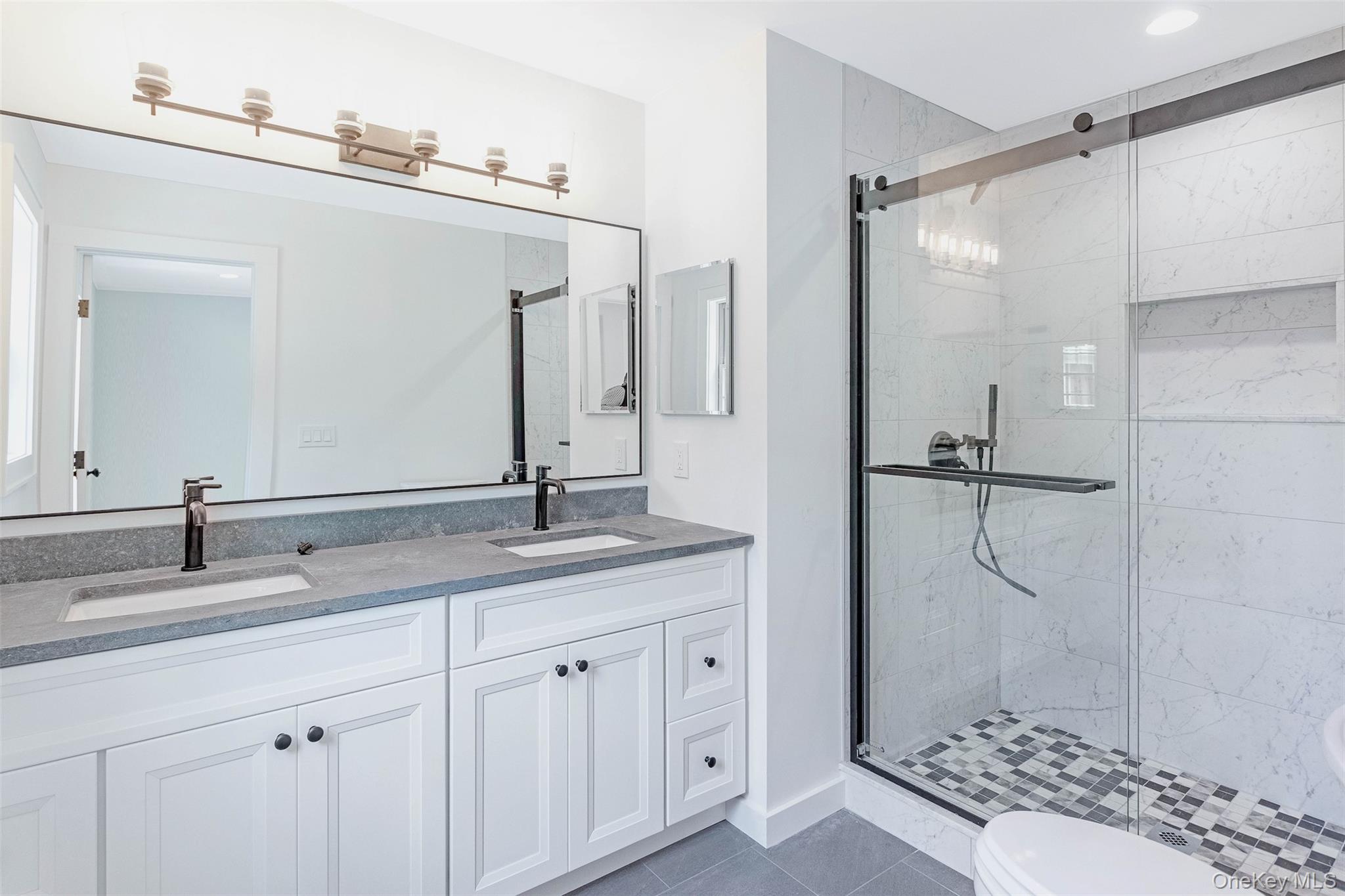130 Sunset Lane Greenport, NY 11944 - Photo 14 of 34 Full bathroom featuring a stall shower, tile patterned floors, and double vanity