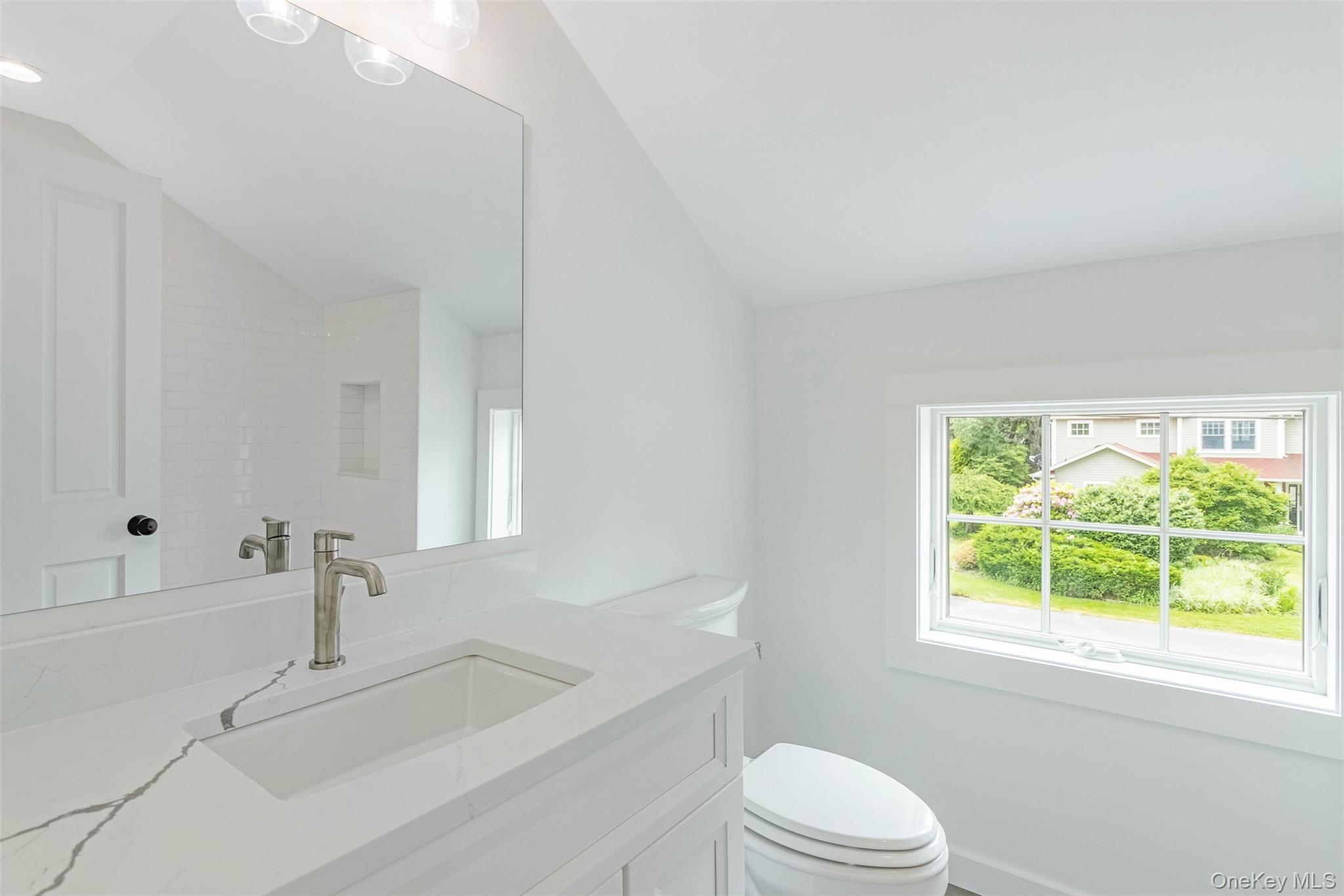 130 Sunset Lane Greenport, NY 11944 - Photo 17 of 34 Bathroom featuring vaulted ceiling and vanity