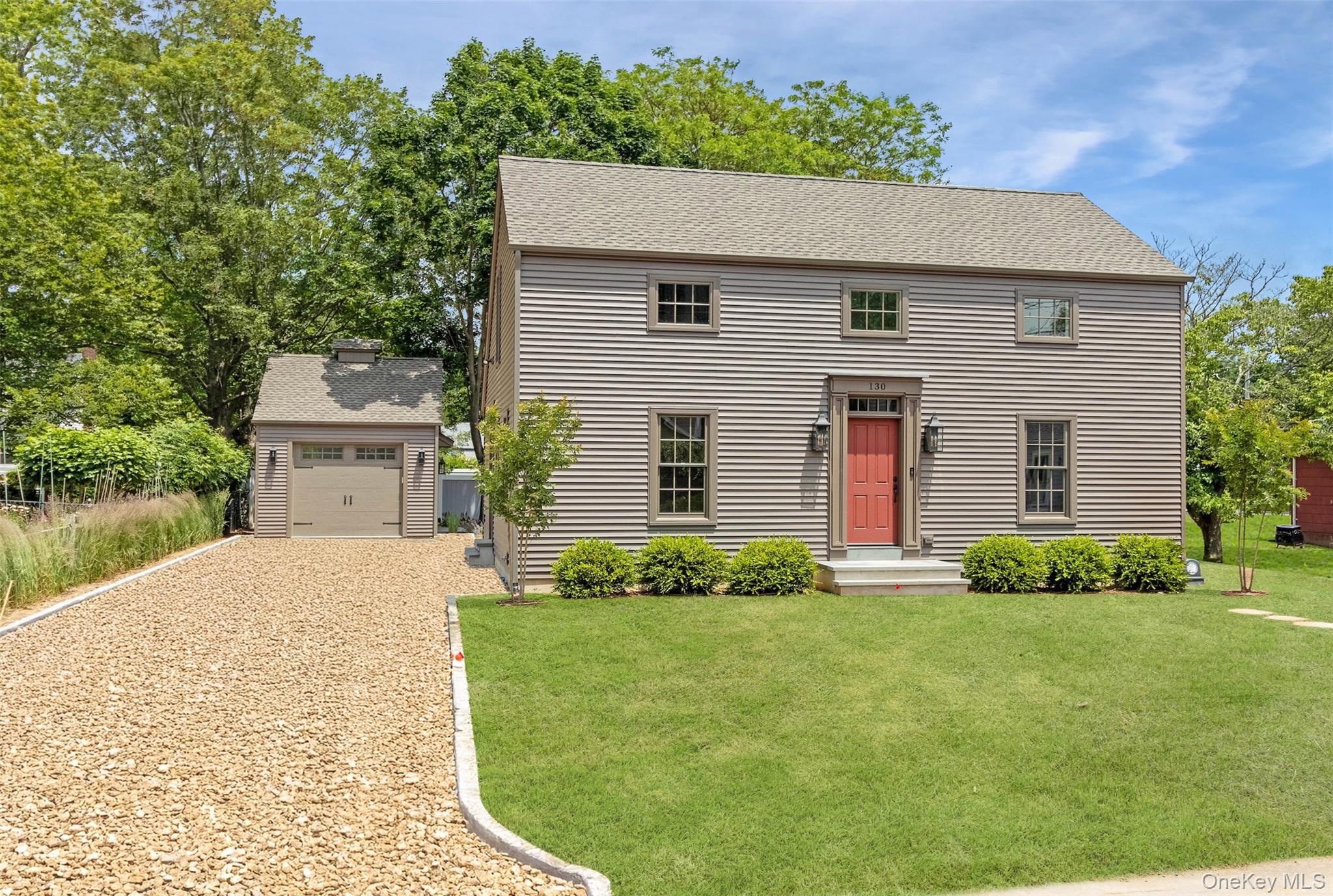 130 Sunset Lane Greenport, NY 11944 - Photo 2 of 34 Colonial inspired home featuring gravel driveway, an outbuilding, a front yard, and roof with shingles