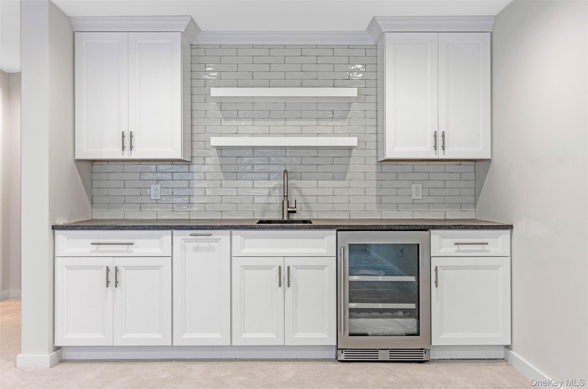 130 Sunset Lane Greenport, NY 11944 - Photo 24 of 34 Indoor wet bar with wine cooler and backsplash