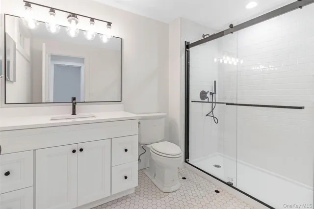 a kitchen with granite countertop white cabinets and a sink