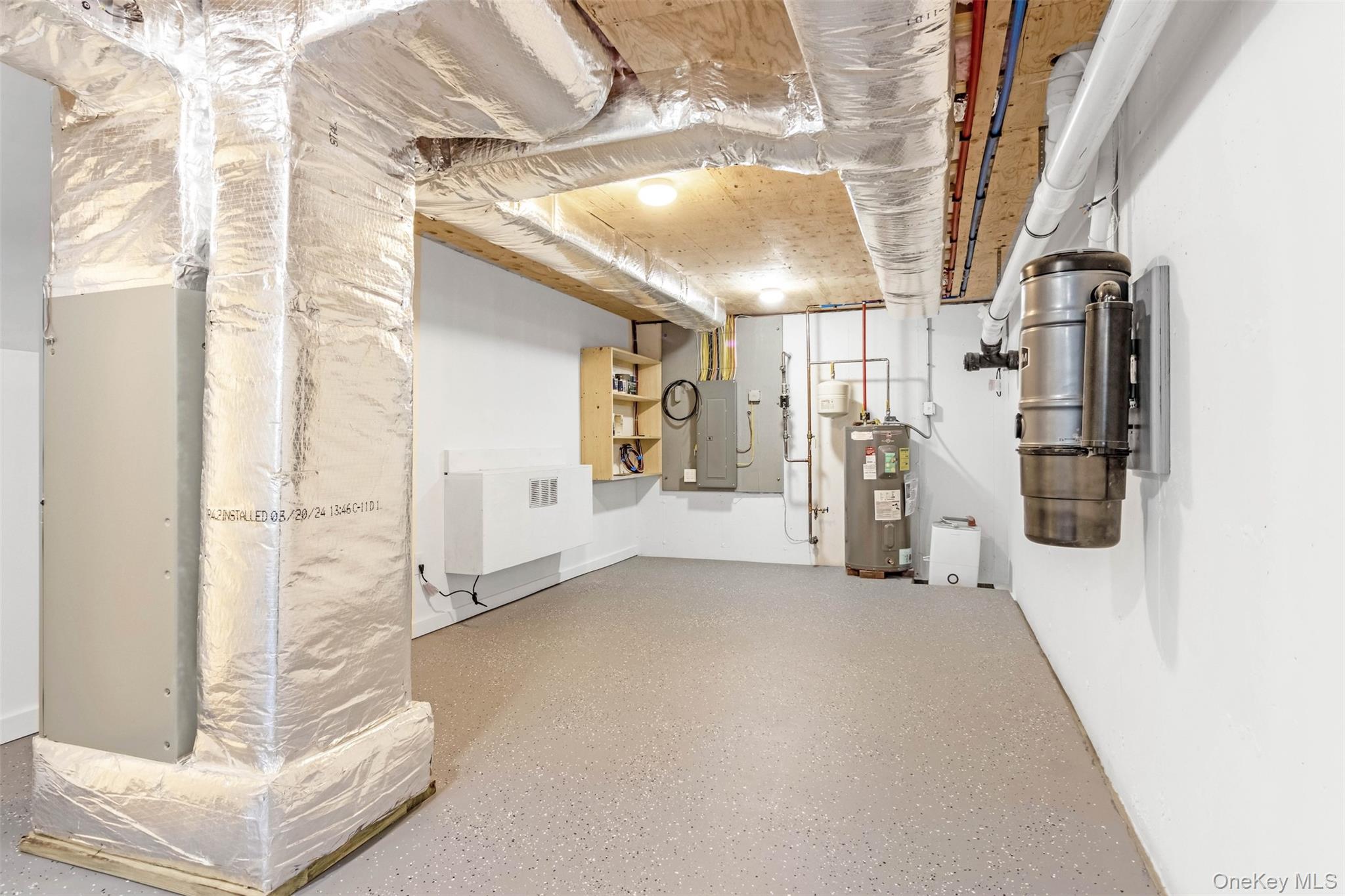 130 Sunset Lane Greenport, NY 11944 - Photo 26 of 34 Unfinished below grade area featuring electric water heater and electric panel