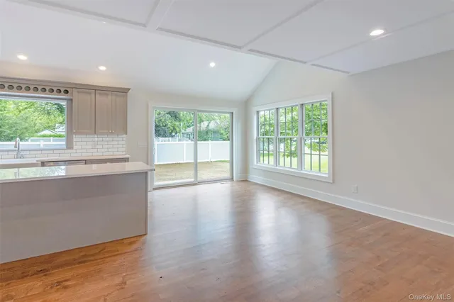 an empty room with wooden floor and a window